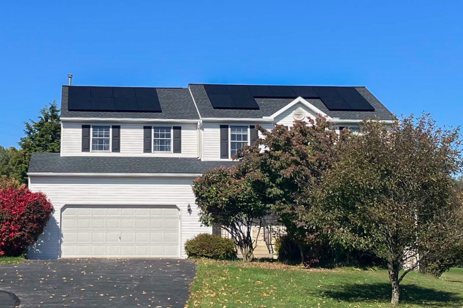 solar panels divided between section of roofing on a two story home with gray shingle roofing
