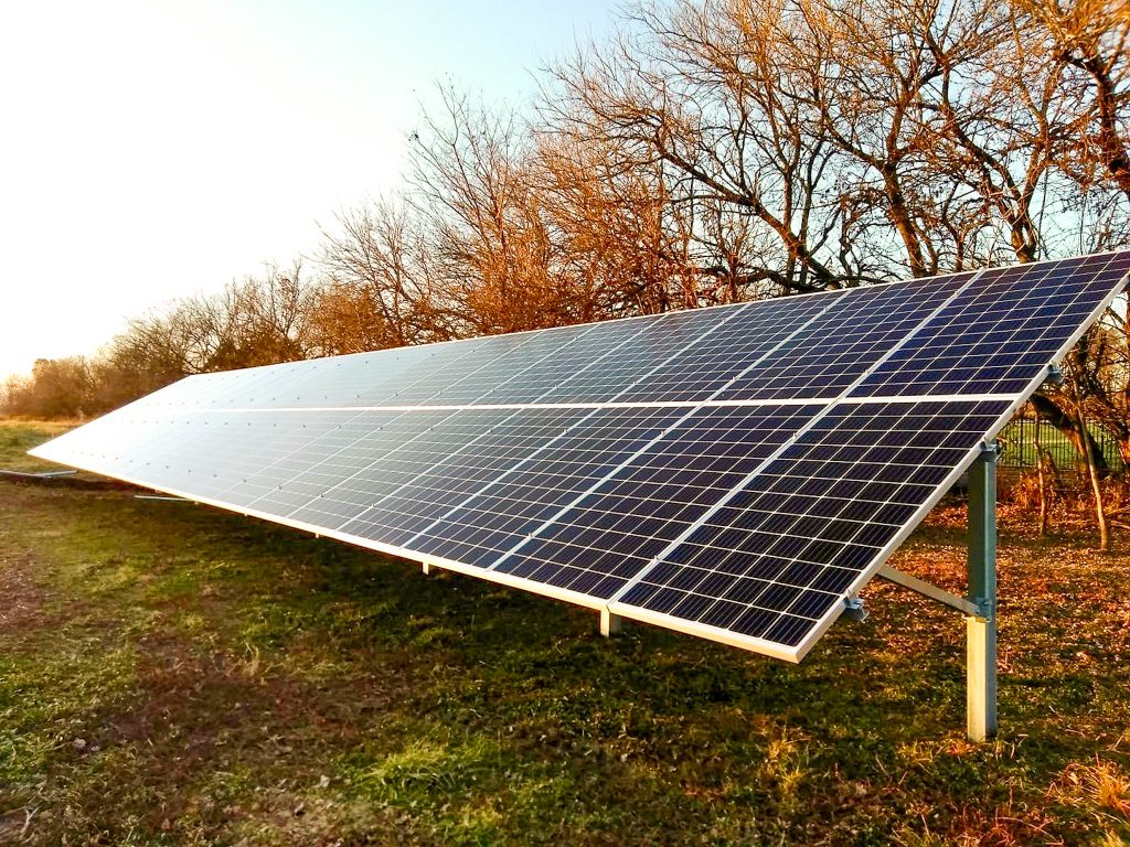Long rows of solar panels installed along leafless tree-lined property in autumn - Solar system installation by top Solar Installer In Willow Street PA
