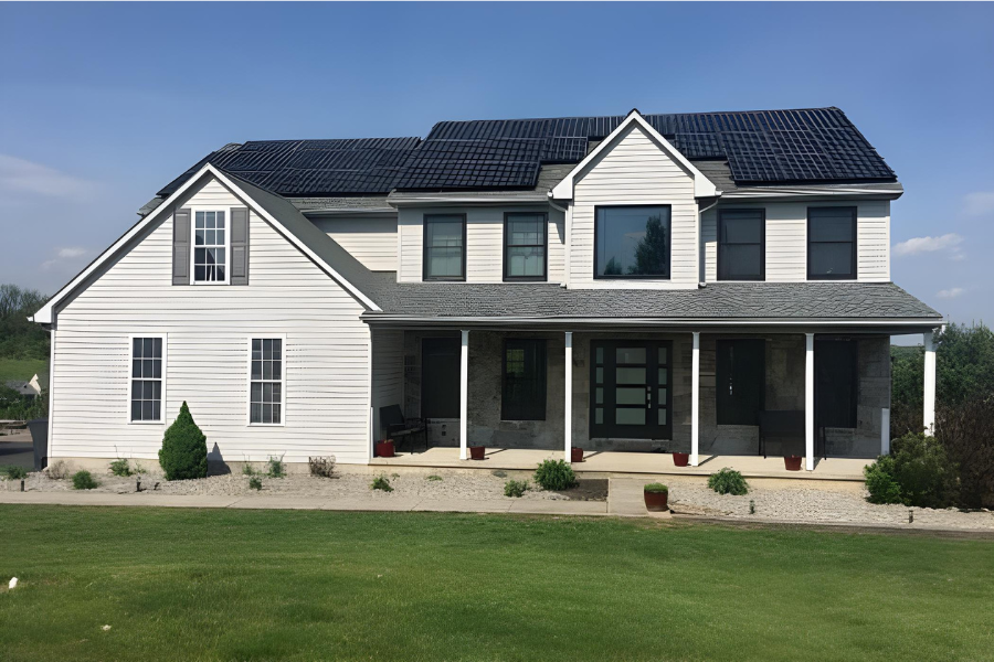 light gray/white residential two story home with gray shingle roof and solar panels