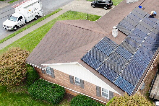 solar panels being installed on roof mounts
