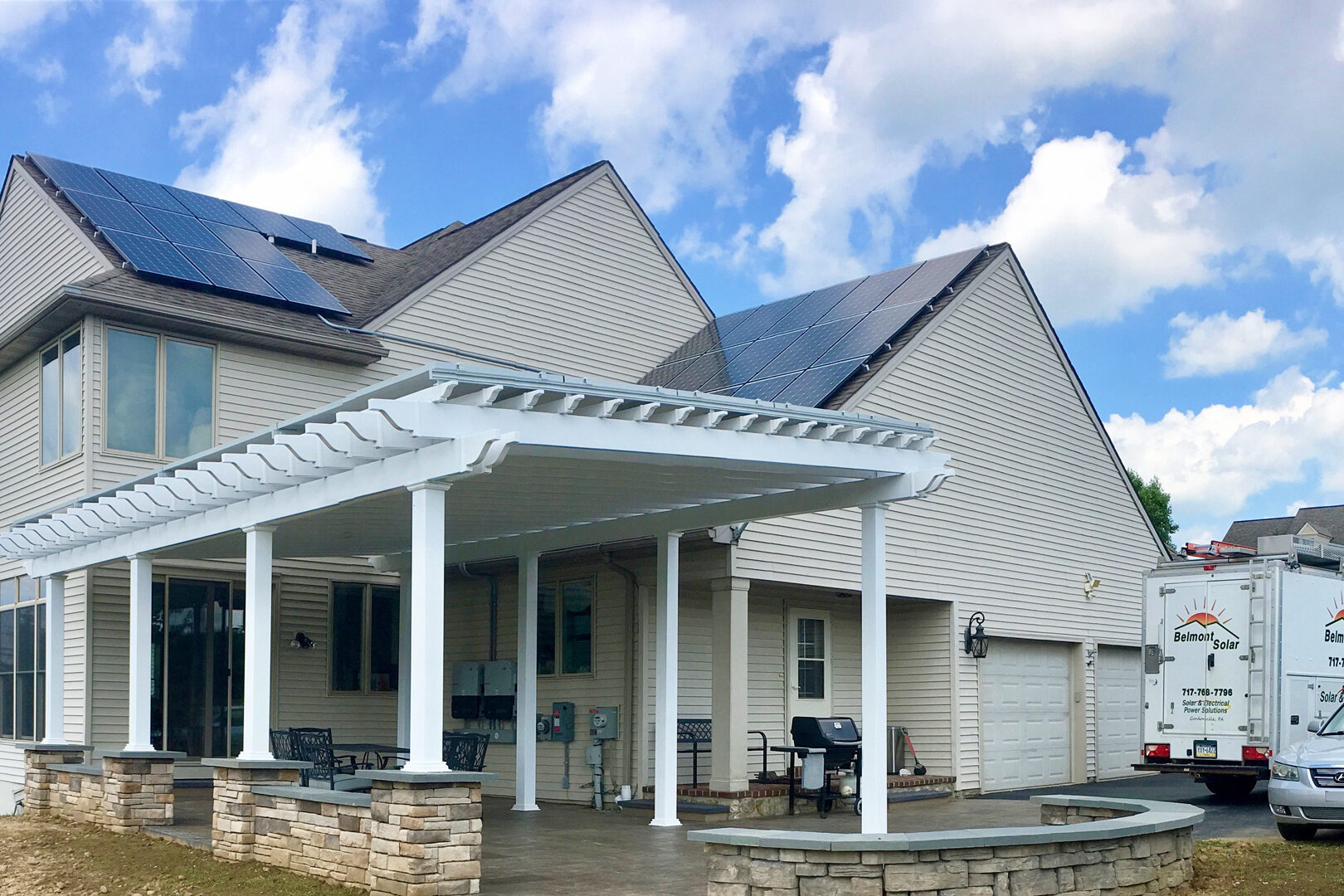 home with pergola in pa featuring solar panels on the roof