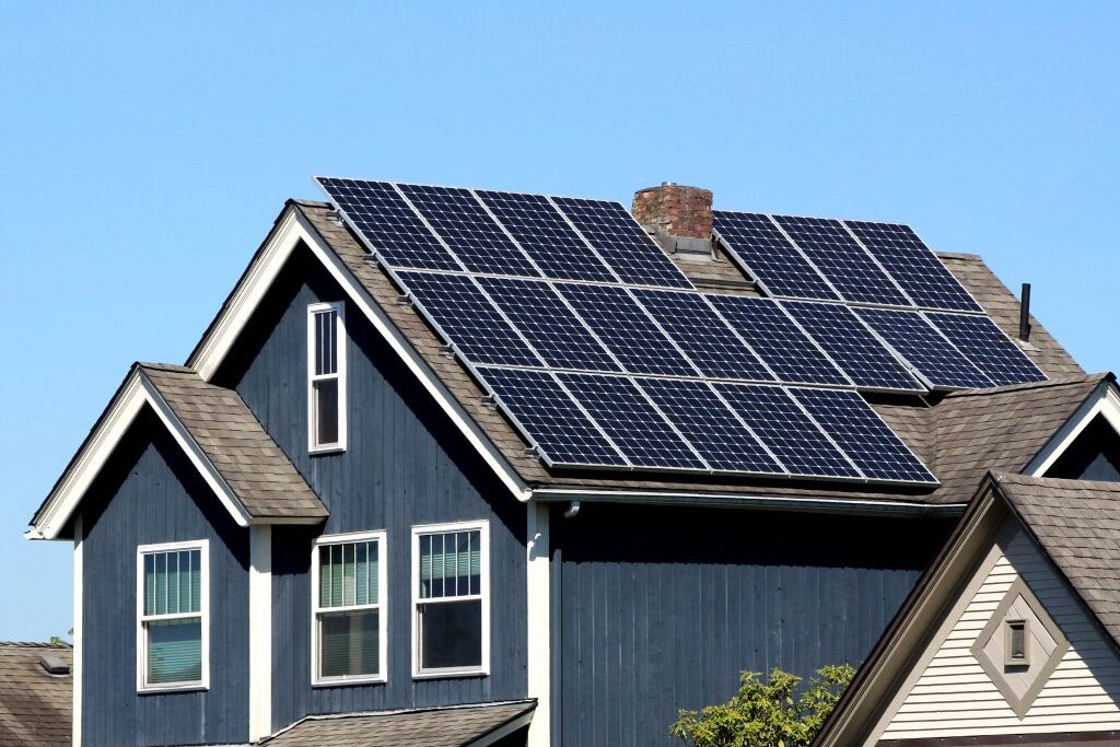 solar panels on shingle roof of blue and white trimmed home