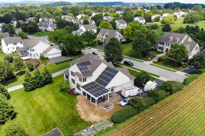 side aerial view of home with solar panels in pa