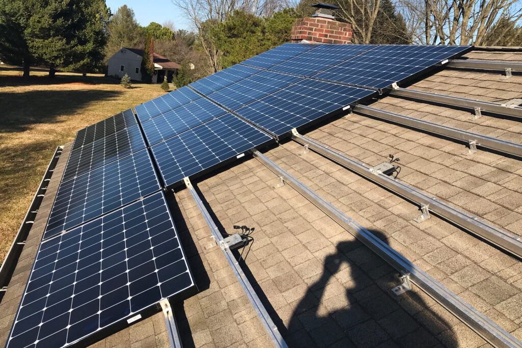 installer adding solar panels to existing system on home