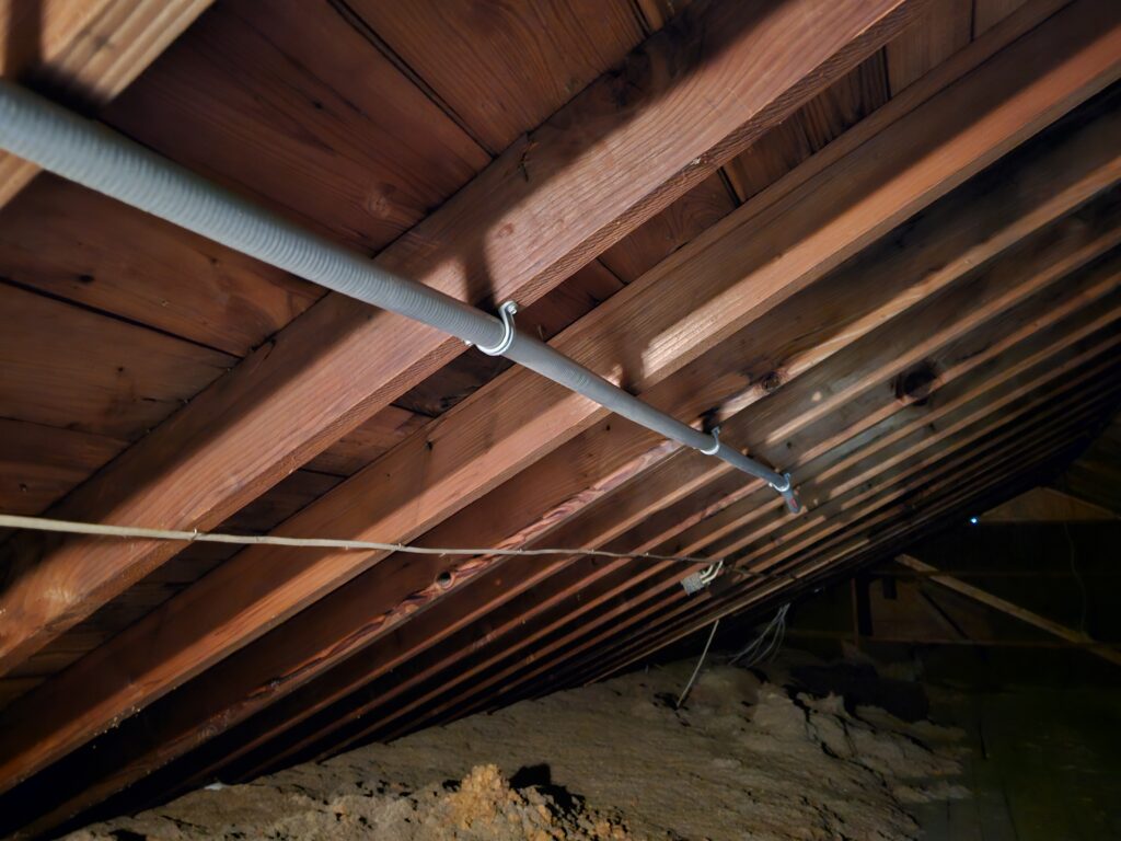 Power conduit fastened to rafters of attic in home in Denver, PA