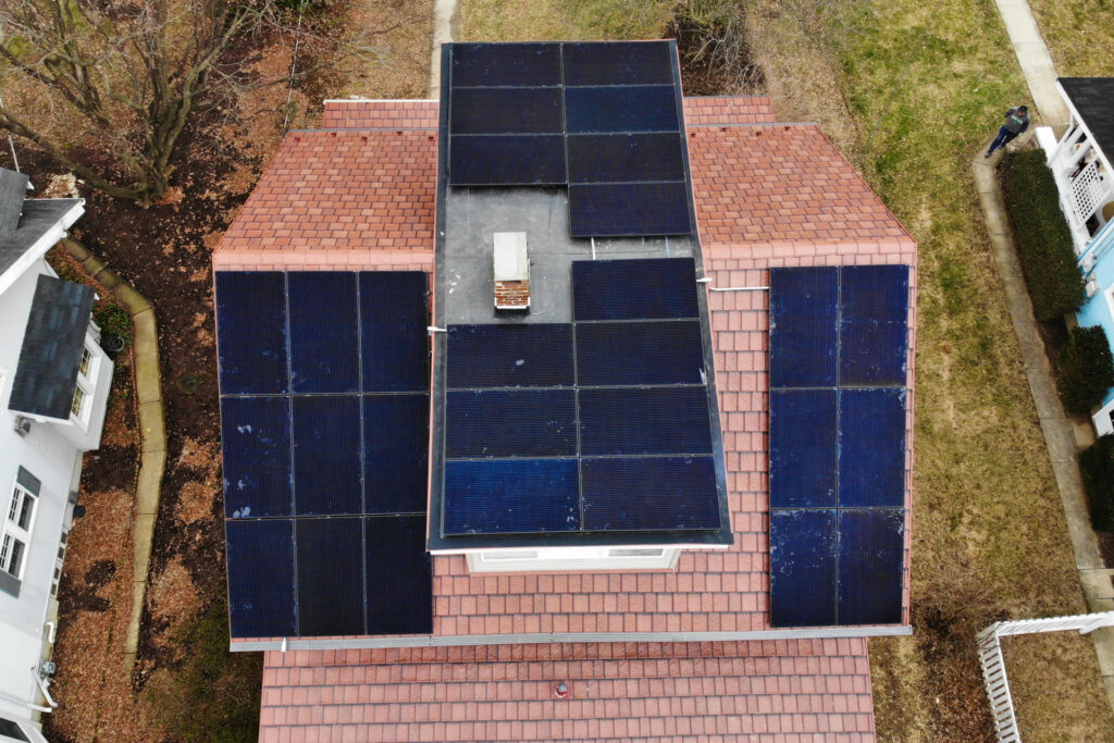 a solar panel system installed on a red roof by a solar installer in paoli pa