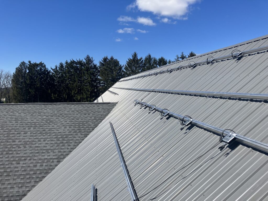 Tough Trac panel mounting system being installed on a metal roof for a 30.75kw solar system in mount joy pa