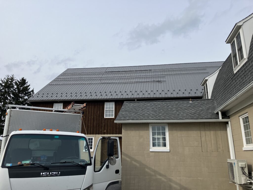 Tough Trac panel mounting system being installed on a metal roof in mount joy pa