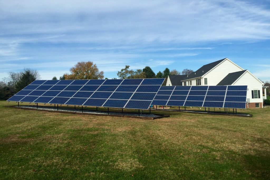Solar panels in yard on mostly sunny day