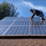 man installing solar panel on net zero home in West Chester, PA
