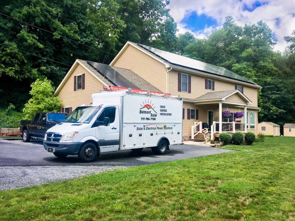car parked outside of residential property to perform solar panel installation